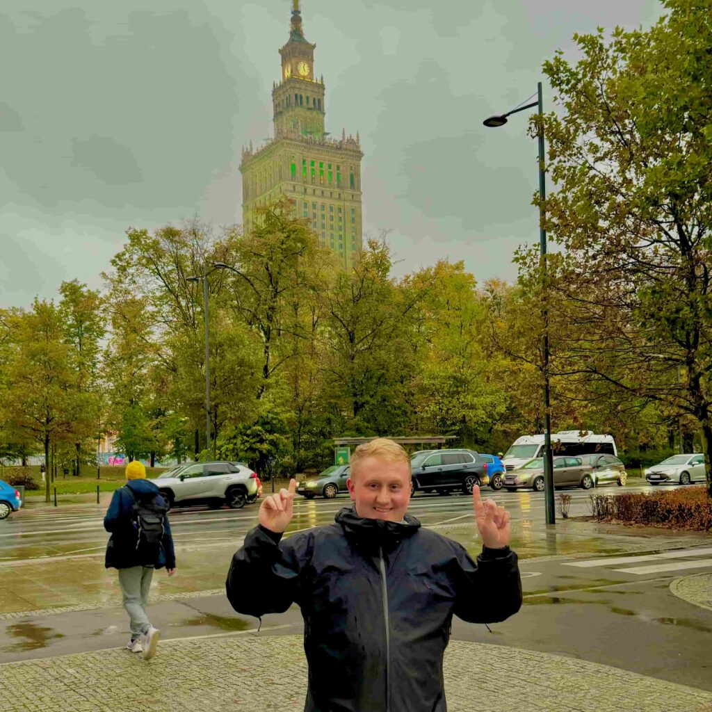 Standing in front of the Palace of Culture and Science in Warsaw, Poland.