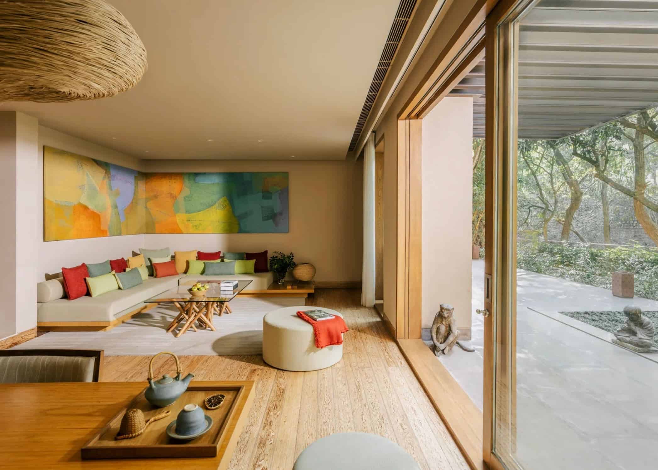 - Bright guest lounge at Six Senses Vana in Dehradun, India, overlooking the surrounding forest