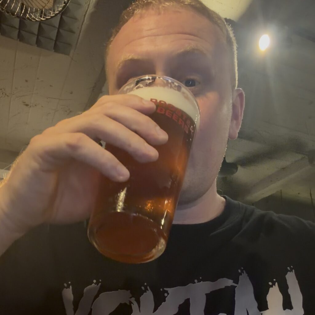 Josh enjoying a pint of craft beer during an evening out in Hanoi.