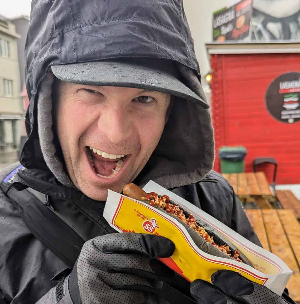 matt sawicki eating a vegan hot dog in iceland