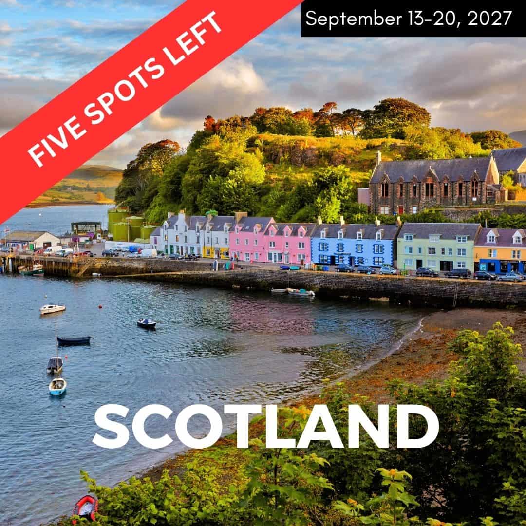 harbor in scotland with colorful houses as the sun is setting